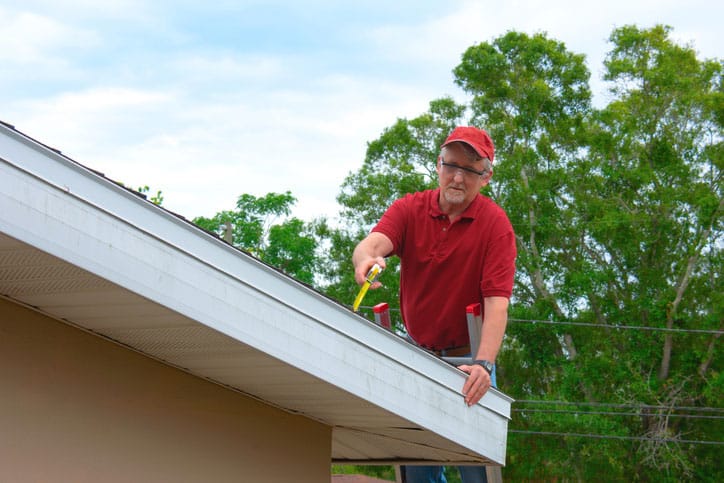 Roof Inspector With Red Shirt and Hat